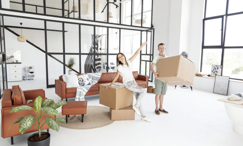 long-shot-couple-being-happy-about-new-house - مرينا لتجارة اثاث مستعمل
