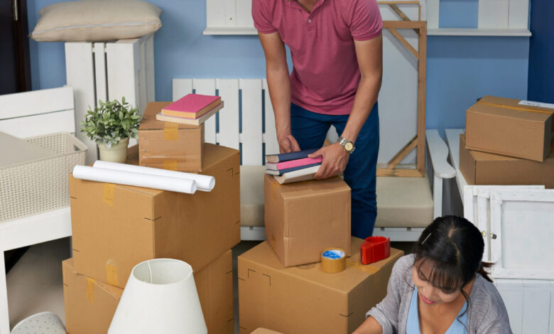 Couple Unpacking Boxes At Home - مرينا لتجارة اثاث مستعمل